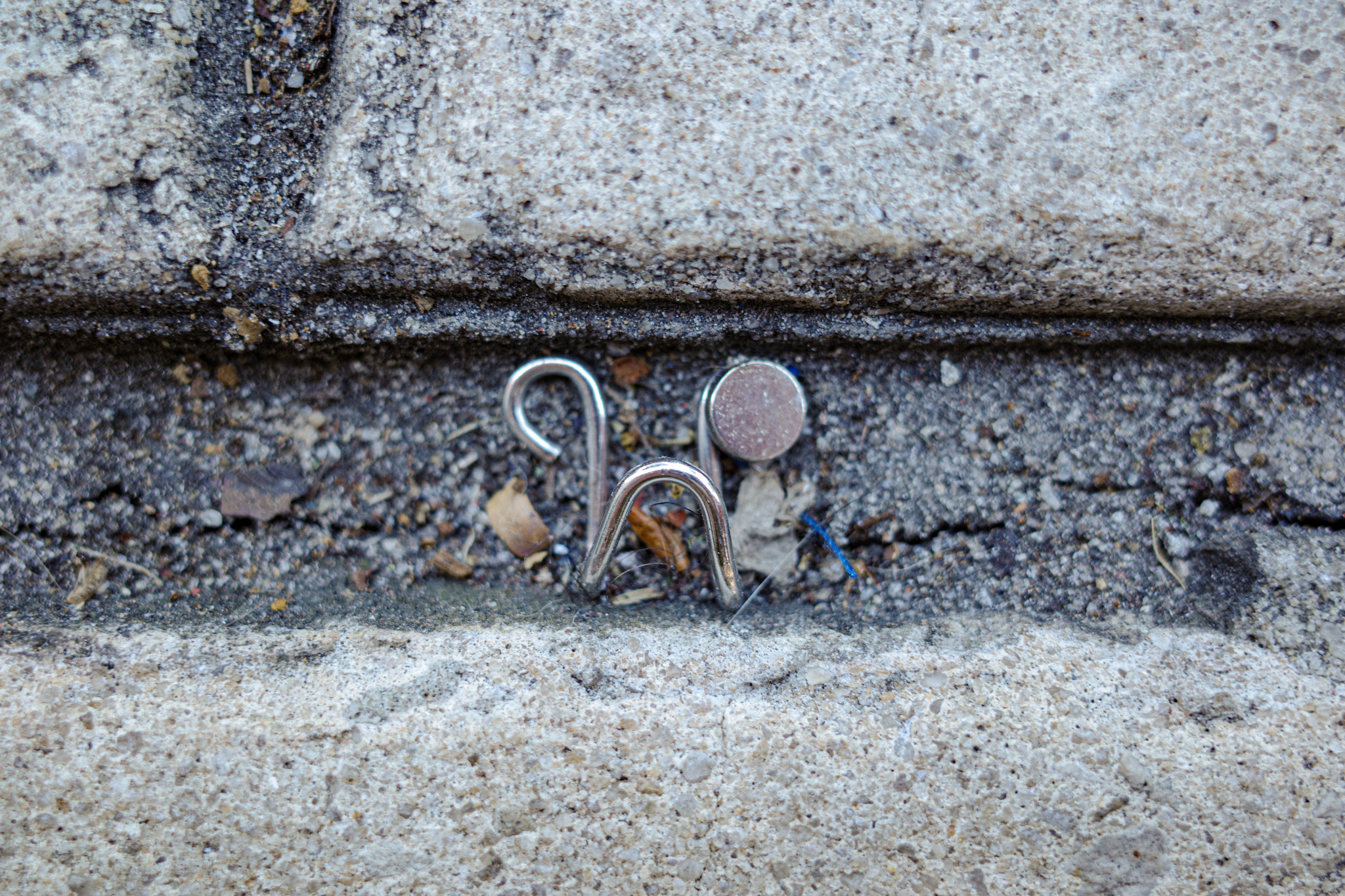 Metal clip fallen between the cracks