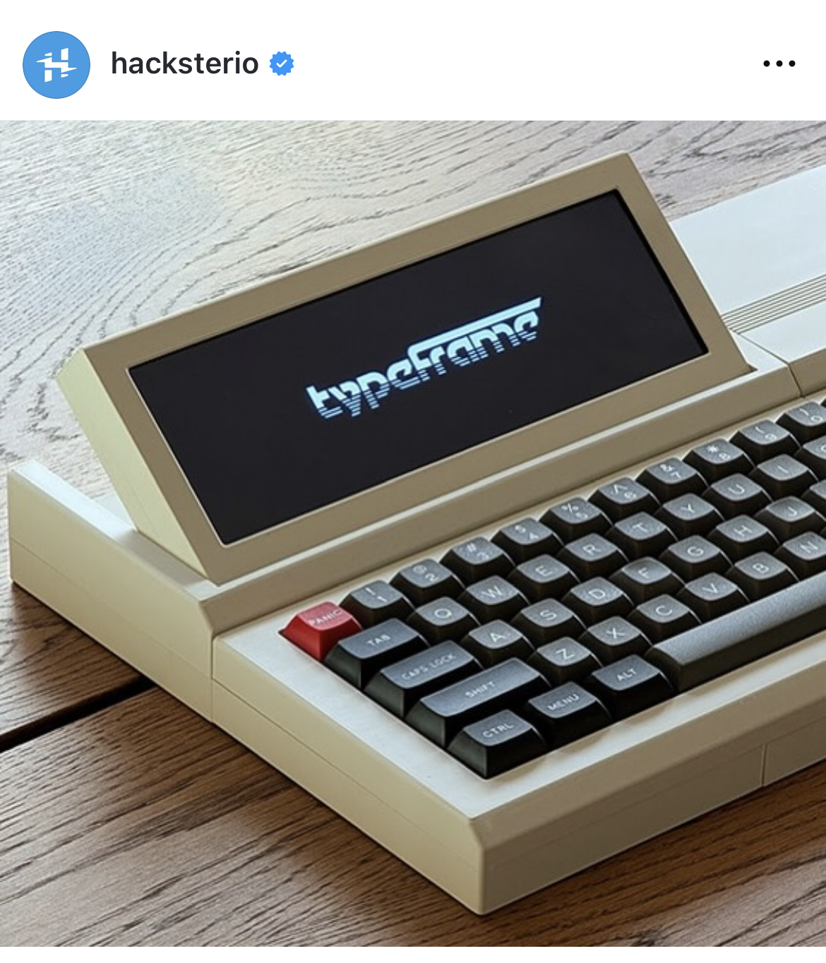 Small retro-style computer with fat mechanical keycaps and a folding display