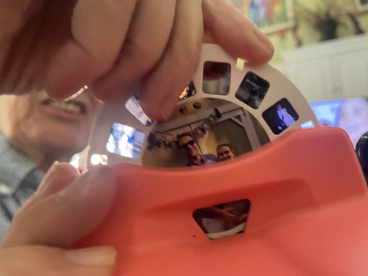 A View-Master reel held in hand, slightly out of focus