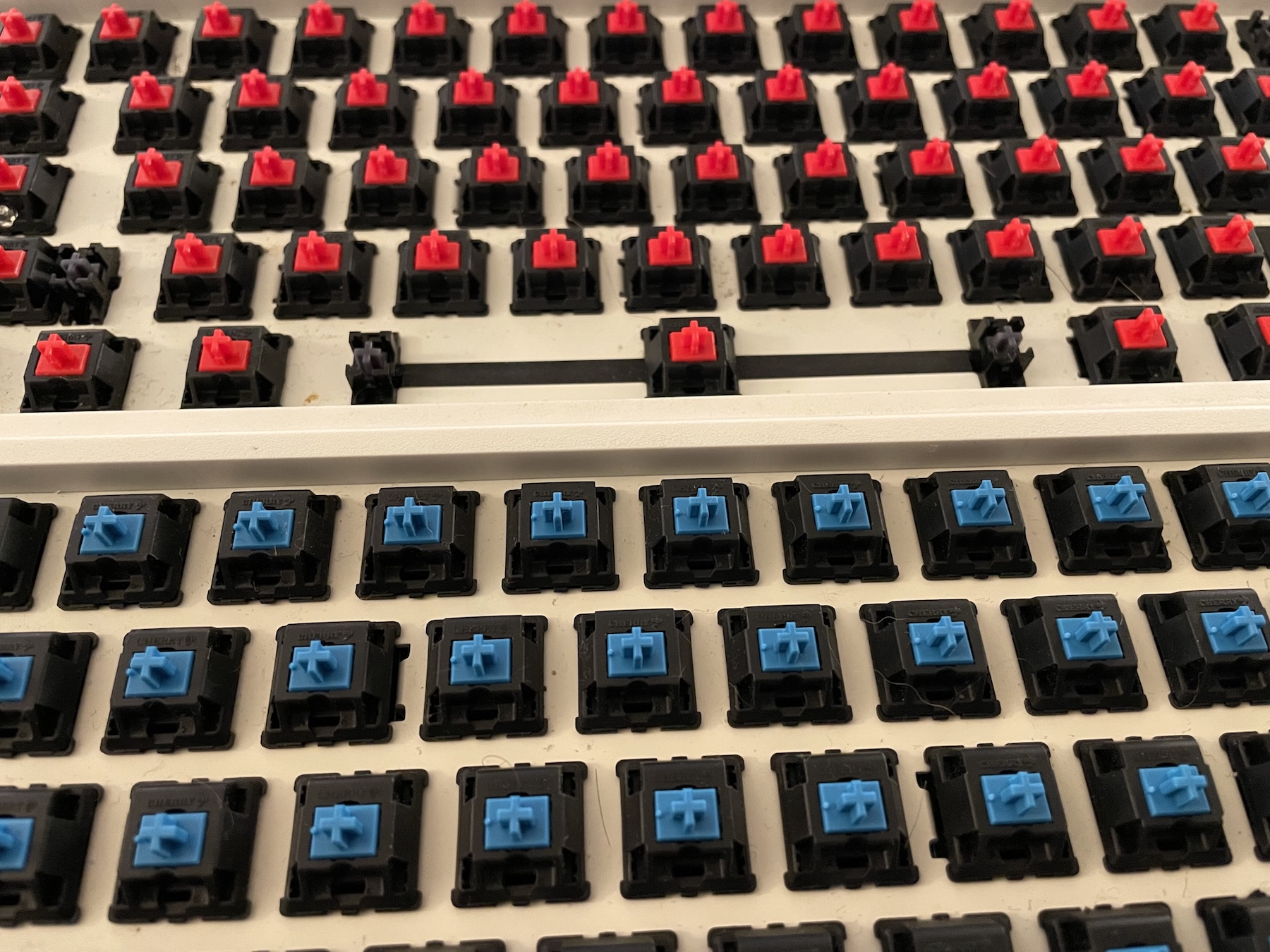Mechanical keyboard with switch housings removed, mid-cleaning