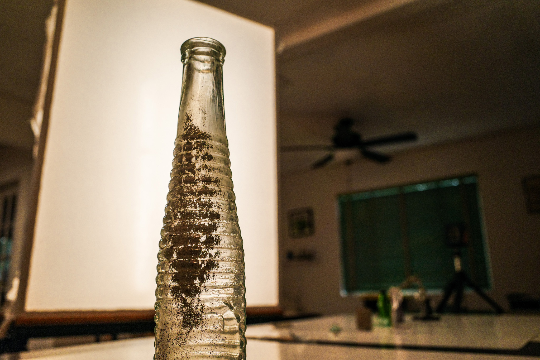 An illuminated bottle with softbox lighting