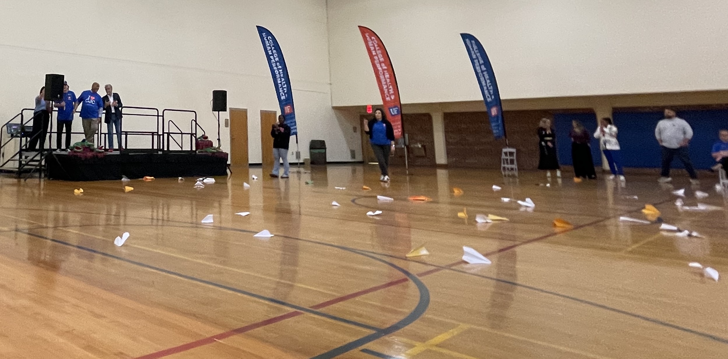 Thrown paper airplanes lay on the floor of the Florida Gym