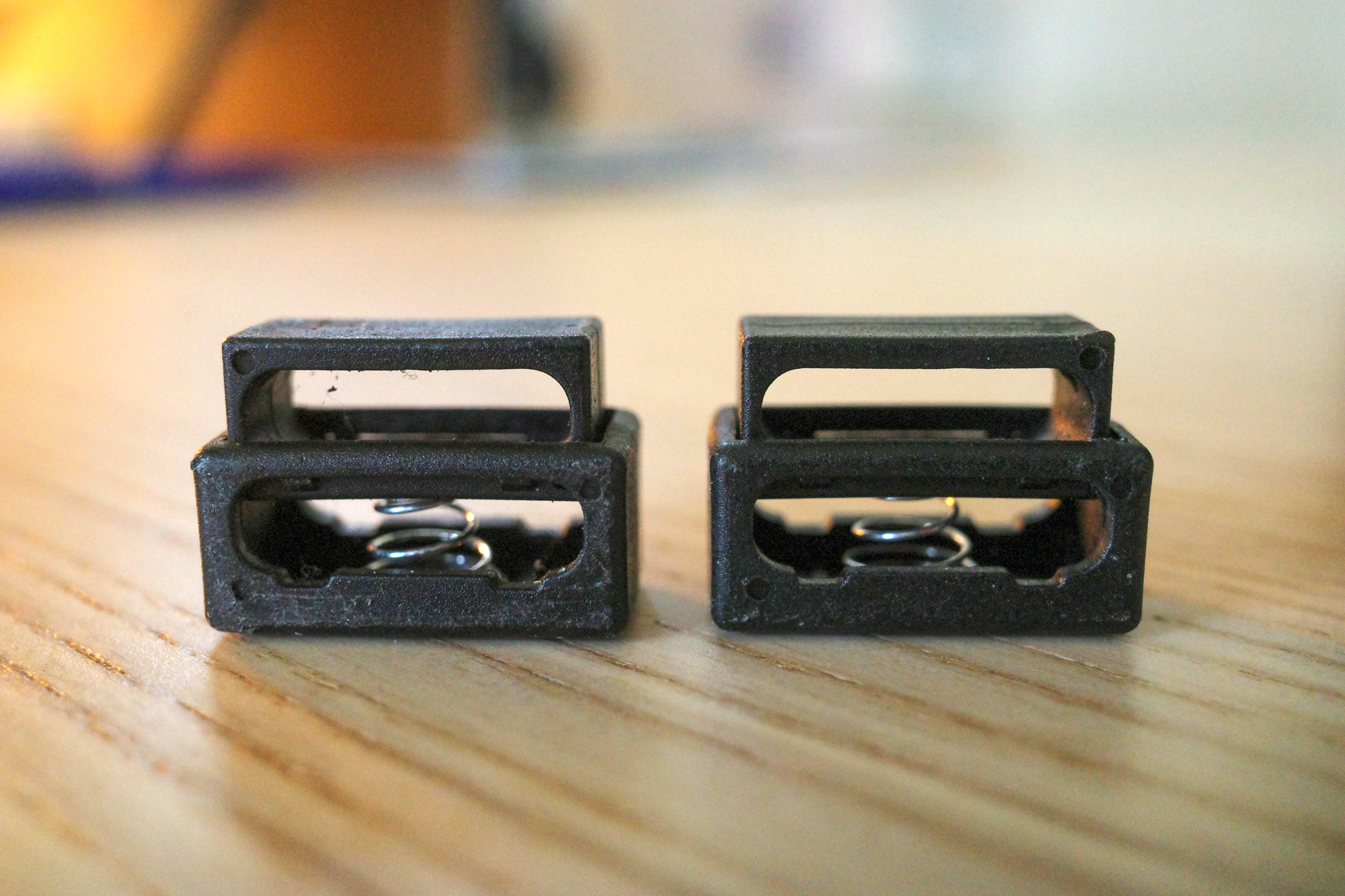 Close-up of two black spring clips found throughout the stadium grounds.