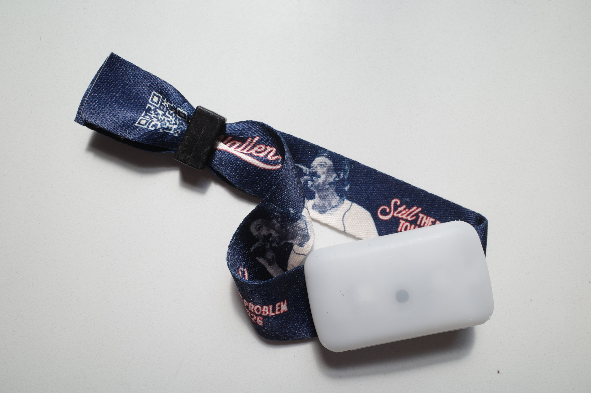 A complete concert wristband light photographed in bright light.